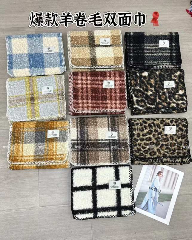Collection of 10 double-sided boucle wool face towels in plaid, leopard, and check patterns displayed flat on floor