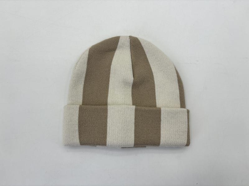 Knit cuffed beanie hat with wide vertical tan and cream stripes, laid flat on white background