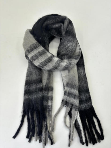 Soft fluffy black and grey striped winter scarf with knotted loop and long fringe tassel ends, laid flat on white background