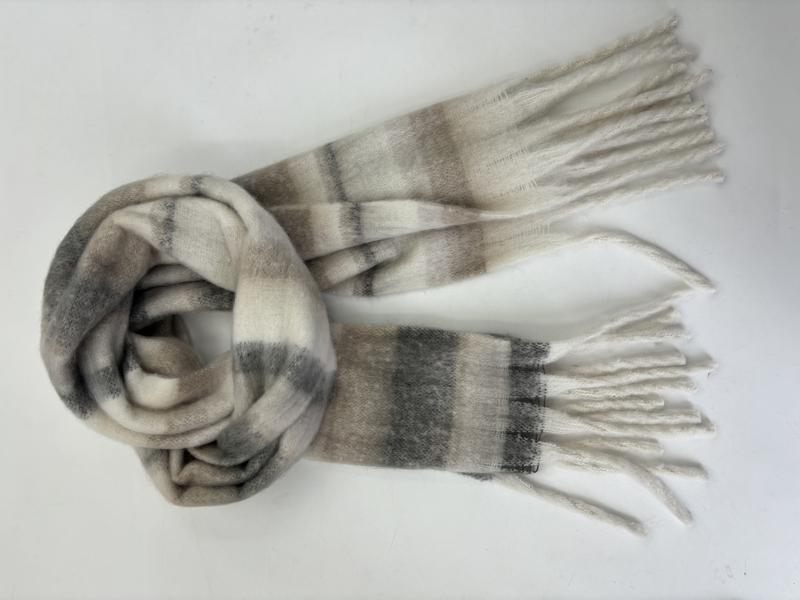 Cream and grey plaid brushed winter scarf with white fringe ends, loosely looped on white background