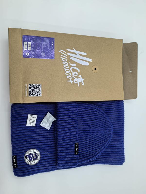 Royal blue ribbed knit beanie hat and matching scarf set with logo patch, displayed with kraft paper gift box packaging