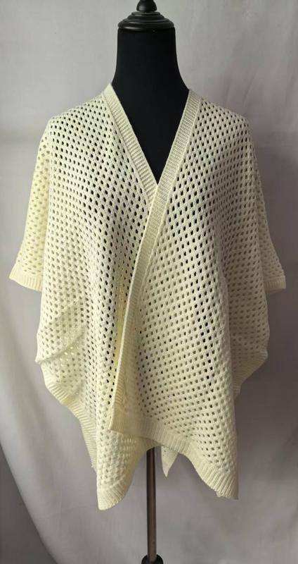 Cream open-weave knit kimono cardigan wrap displayed on black mannequin, featuring mesh stitch pattern and draped open front