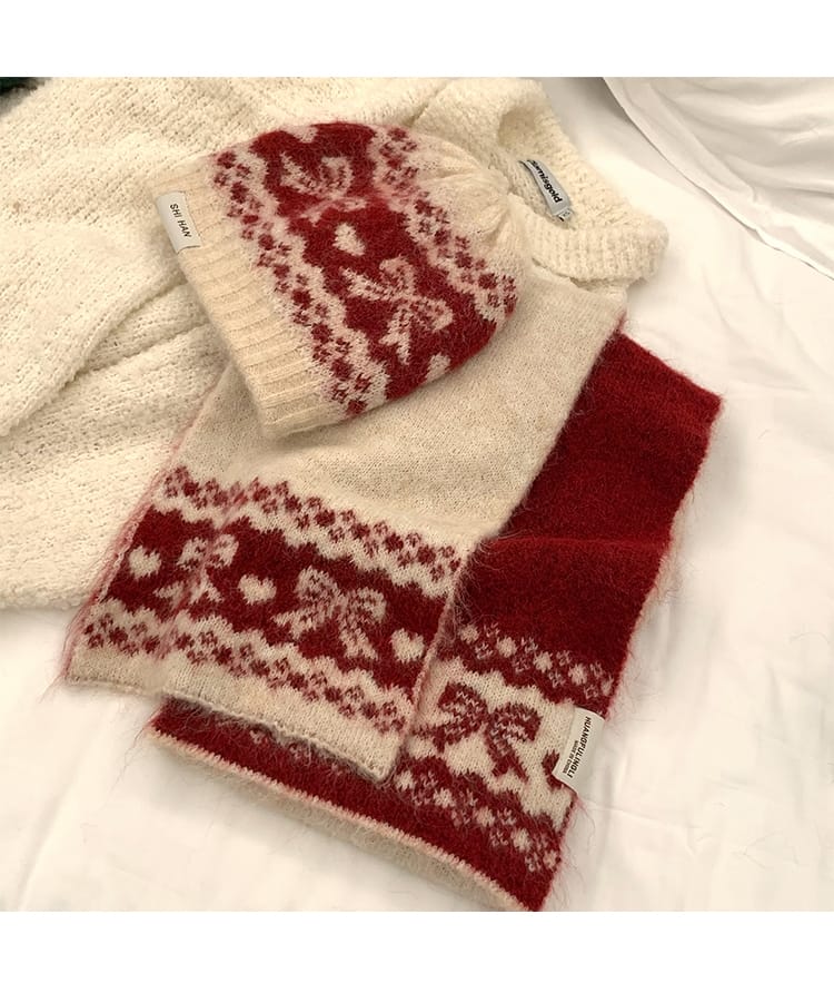 Cream and red Fair Isle patterned knit beanie hat and matching scarf set with heart and floral motifs on white background
