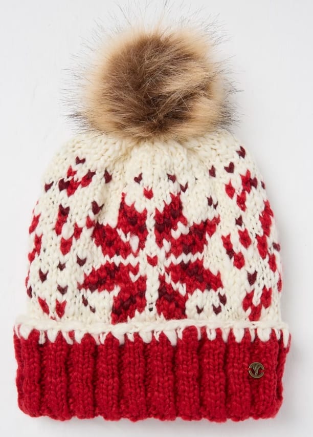 Red and cream chunky knit Fair Isle patterned winter beanie hat with large faux fur pom pom on white background