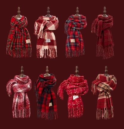 Eight red tartan plaid winter scarves with fringe displayed on mannequins against a dark red background, showing various plaid patterns