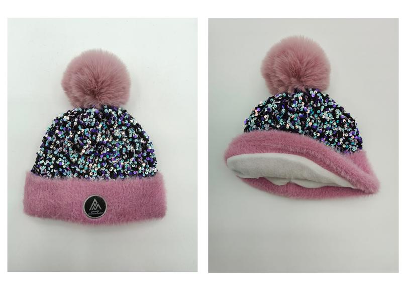 Pink fluffy cuff beanie hat covered in multicolor sequins with large pink faux fur pom pom, shown front and back views