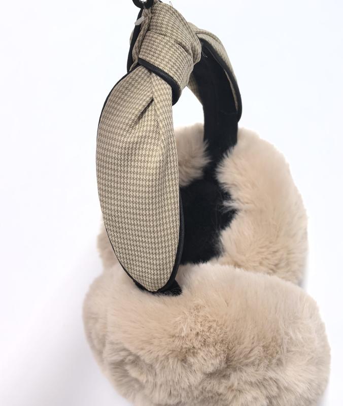 Brown fluffy sherpa fleece earmuffs with curved headband on white background, cozy winter ear warmers
