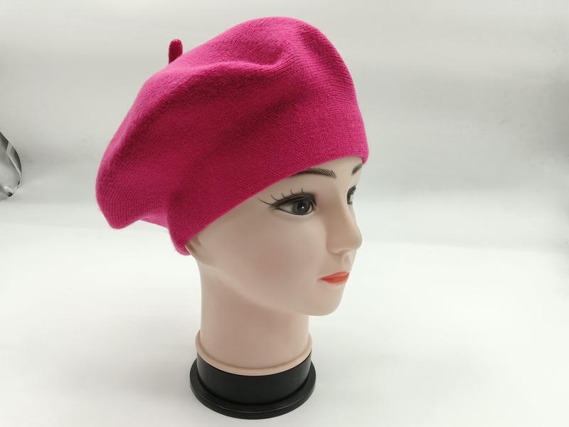 Hot pink wool knit French beret displayed on a female mannequin head, shown from a three-quarter side angle