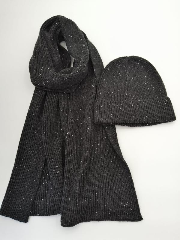 Dark charcoal ribbed knit scarf and matching beanie hat with white fleck speckle pattern on white background