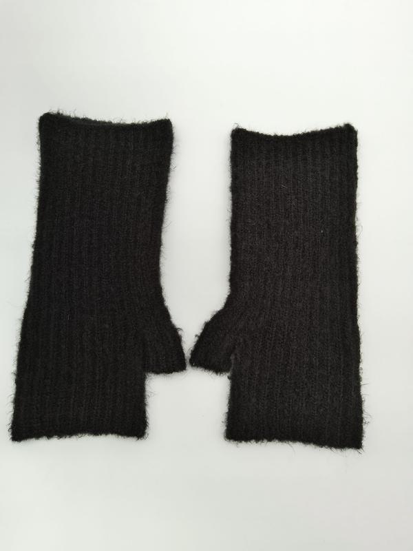 Pair of black ribbed fingerless gloves with fuzzy mohair-blend texture and thumb hole, laid flat on white background