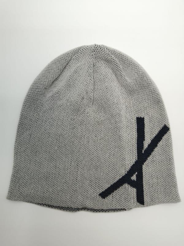 Light grey fine knit slouch beanie hat with large navy blue letter graphic on front, laid flat on white background
