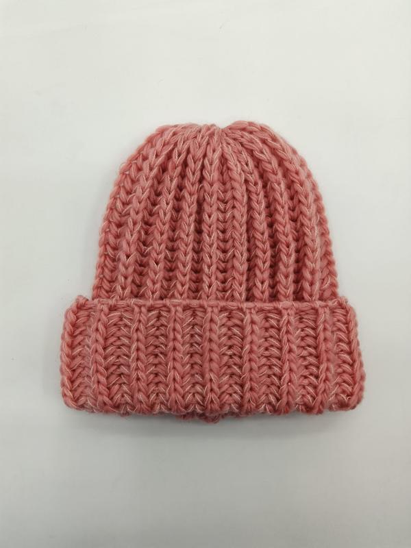 Dusty rose pink chunky ribbed knit beanie hat with folded cuff, laid flat on white background