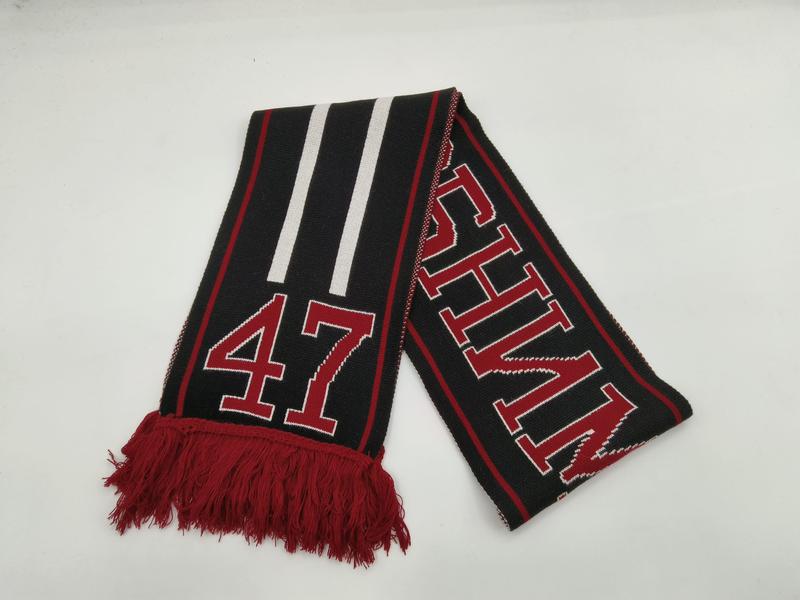 Black knitted sports fan scarf with red and white stripes, number 47, bold lettering, and red fringe tassels on white background