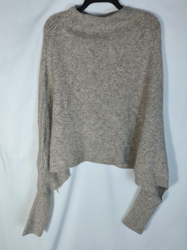 Beige cropped knit sweater with diamond pointelle pattern and long sleeves displayed on hanger