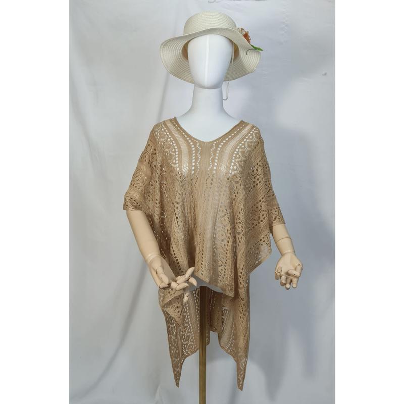 Mannequin wearing beige crochet lace kaftan tunic with V-neckline and wide sleeves, paired with white sun hat