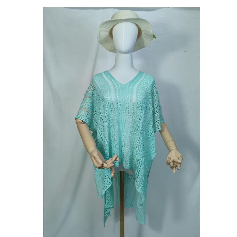 Mannequin wearing aqua mint crochet lace kaftan beach cover-up tunic with V-neck and wide sleeves paired with white sun hat