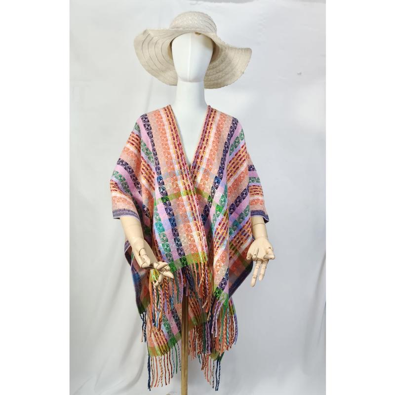 Mannequin wearing multicolor handwoven striped fringe poncho wrap with wide-brim straw hat on white background