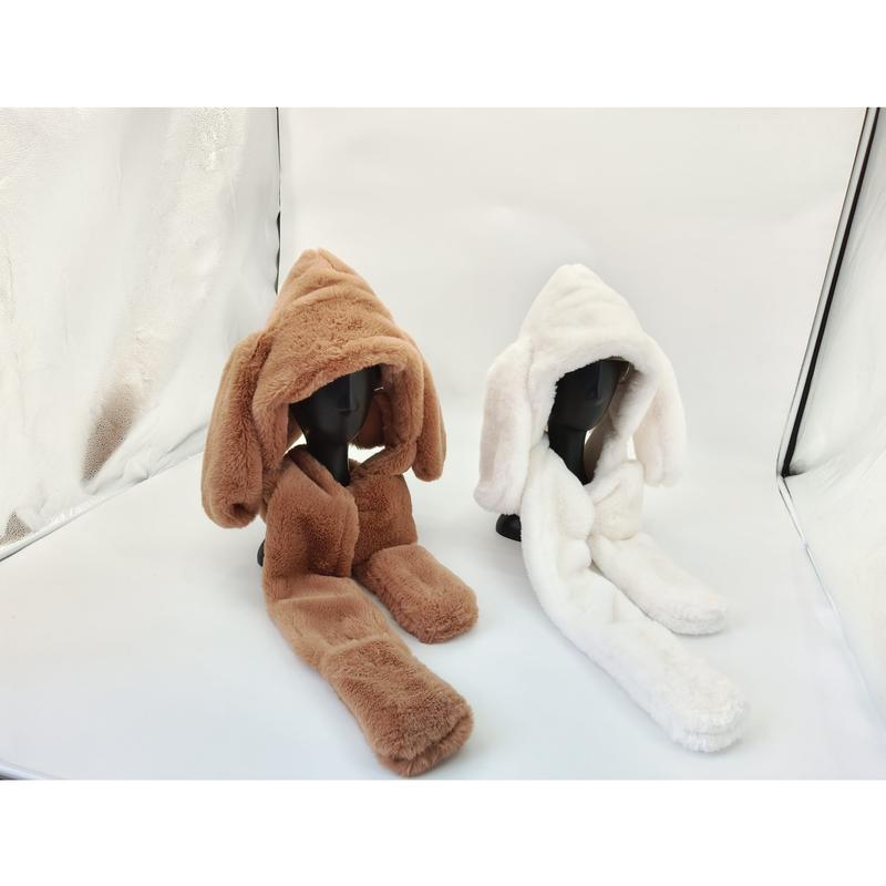 Two faux fur hooded scarves with long bunny ears on mannequin heads, one brown and one white, displayed in studio