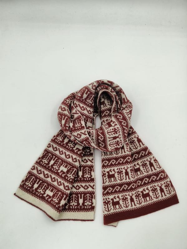 Knitted winter scarf in burgundy and cream with Fair Isle reindeer and Nordic pattern, looped on white background