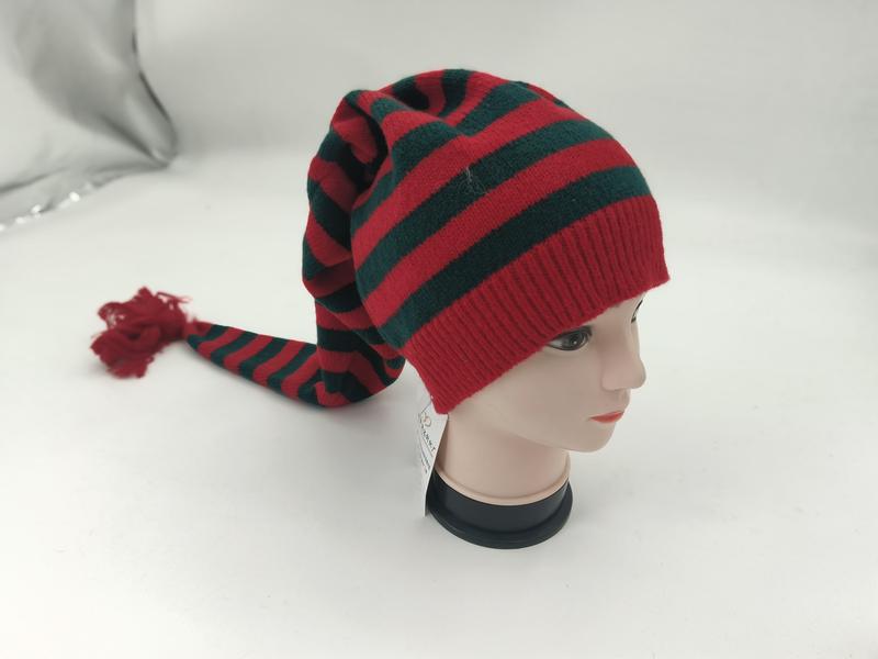 Red and green striped knit Christmas elf hat with long tail and tassel displayed on mannequin head