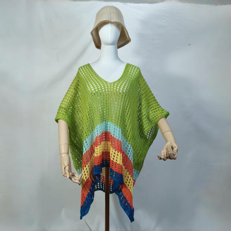 Mannequin wearing green crochet open-knit poncho with rainbow chevron hem and beige bucket hat, beach cover-up