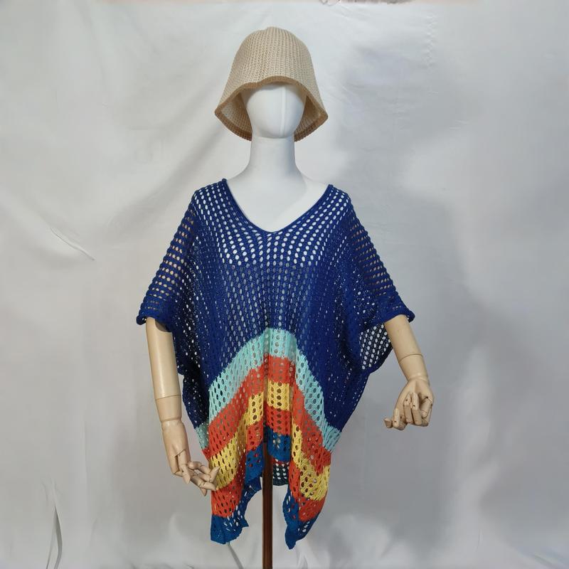 Mannequin wearing blue crochet open-knit poncho with rainbow stripe hem and beige bucket hat on white background