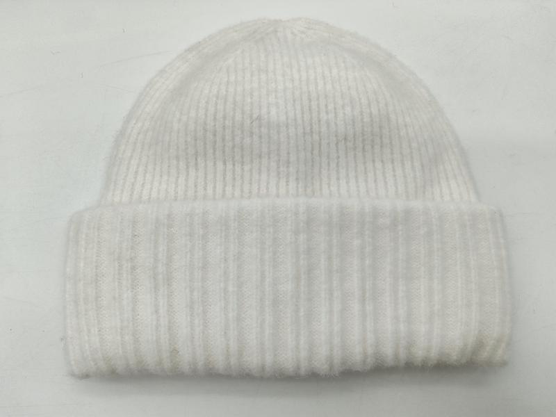 White ribbed knit winter beanie hat with folded cuff displayed flat on white background