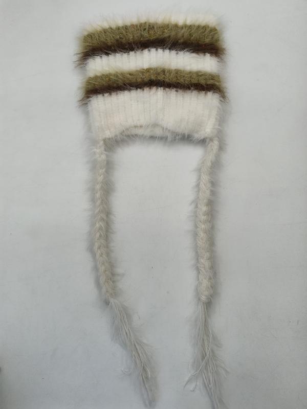 Cream and olive green fuzzy striped knit winter hat laid flat with two long braided tassel ties on white background