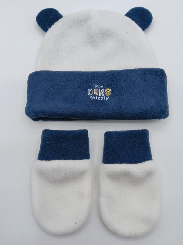 White and navy blue fleece baby hat with bear ears and matching mittens set labeled Mon Ours Grizzly