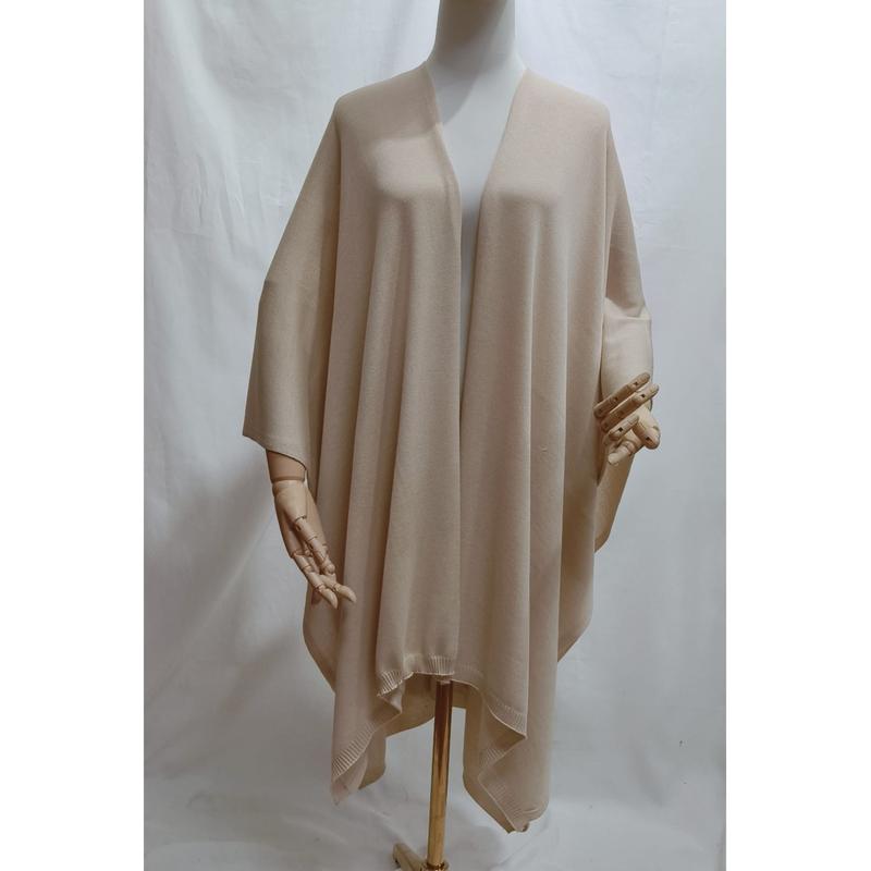 Cream beige open front oversized knit wrap poncho shawl displayed on mannequin with ribbed hem detail