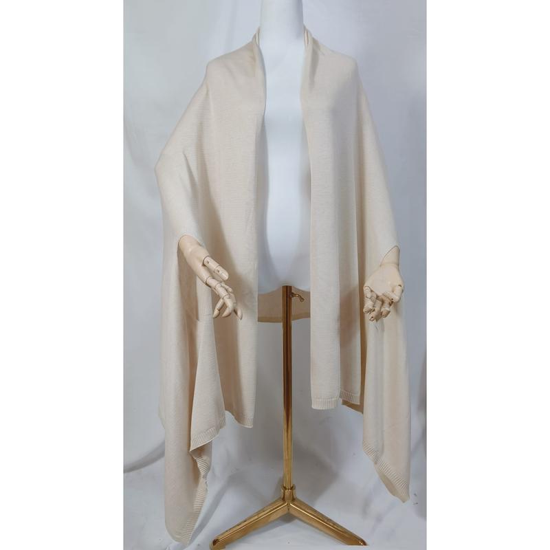 Cream ivory knit wrap shawl draped on mannequin with wooden hands and gold tripod stand, open front poncho style