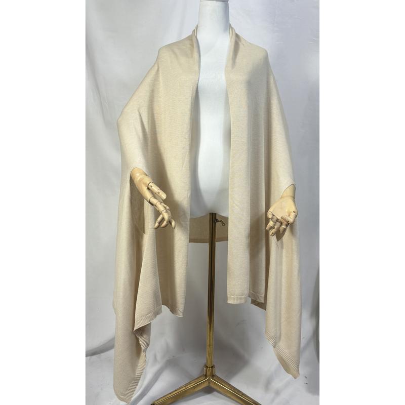 Cream fine knit open-front wrap ruana shawl with ribbed hem trim displayed on a dress form mannequin