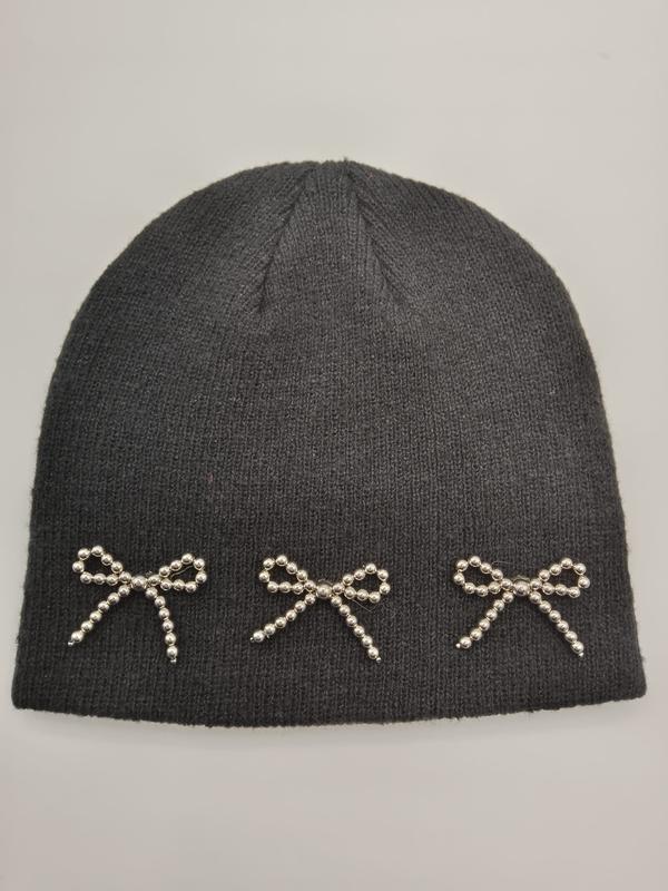 Dark charcoal ribbed knit winter beanie hat featuring three decorative silver beaded bow appliques along the brim