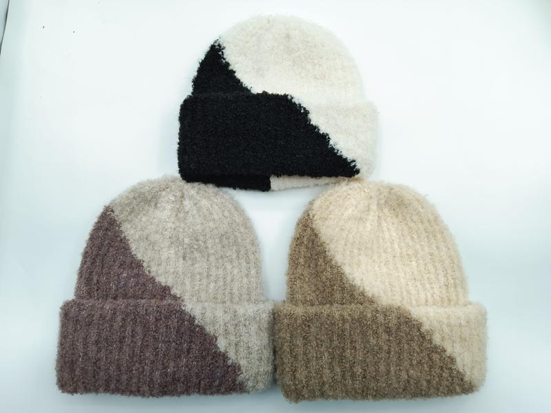 Three two-tone color block fuzzy knit beanies in black-cream, mauve-beige, and tan-cream colorways displayed on white background