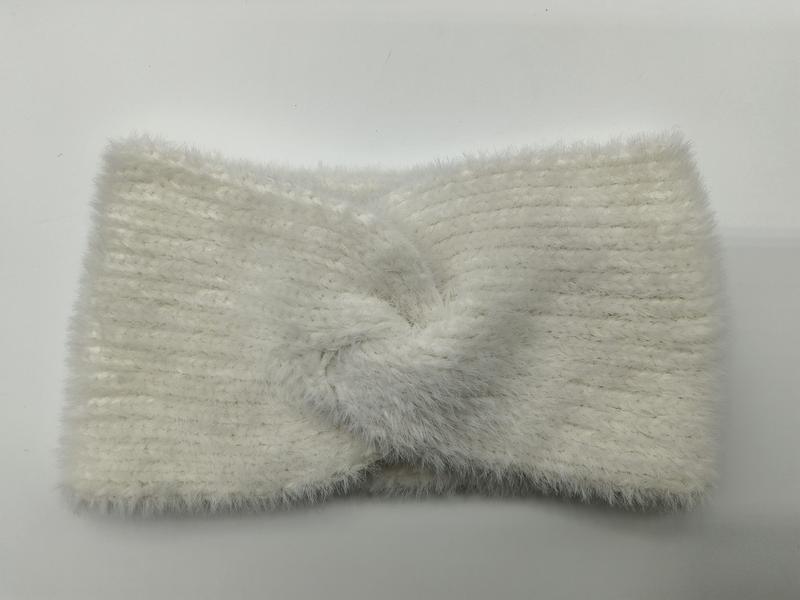 Cream white fuzzy ribbed knit headband with center twist knot detail, laid flat on white background