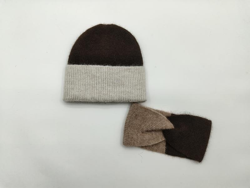 Brown and oatmeal two-tone knit beanie hat with matching dark brown and taupe fingerless gloves set on white background