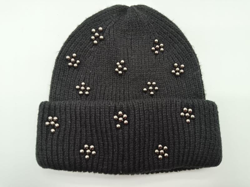 Black ribbed knit winter beanie hat adorned with scattered silver metallic bead flower clusters on folded cuff style