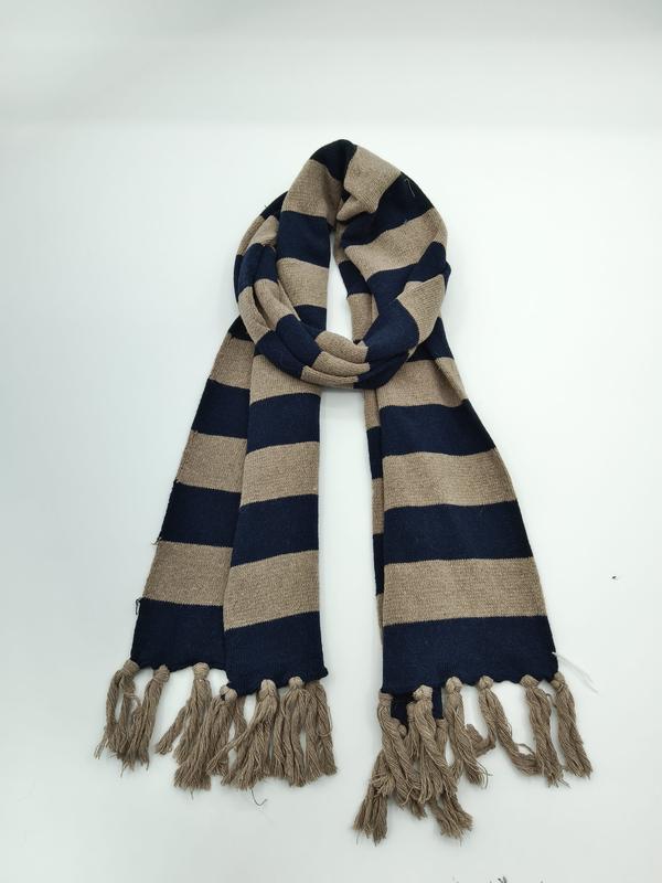 Striped navy blue and beige knit winter scarf looped on white background with tassel fringe ends