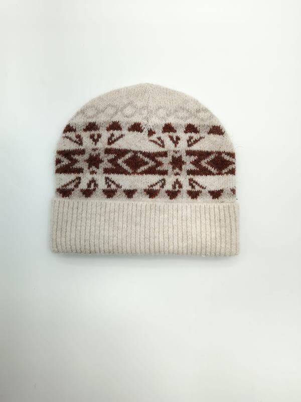Cream knitted beanie hat with rust brown Fair Isle Nordic geometric snowflake pattern and ribbed cuff, flat lay on white background