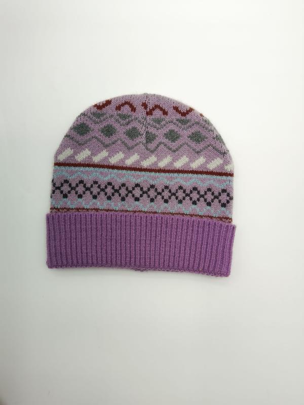 Lilac purple Fair Isle knit beanie hat with multicolor geometric patterns and ribbed cuff, flat lay on white background