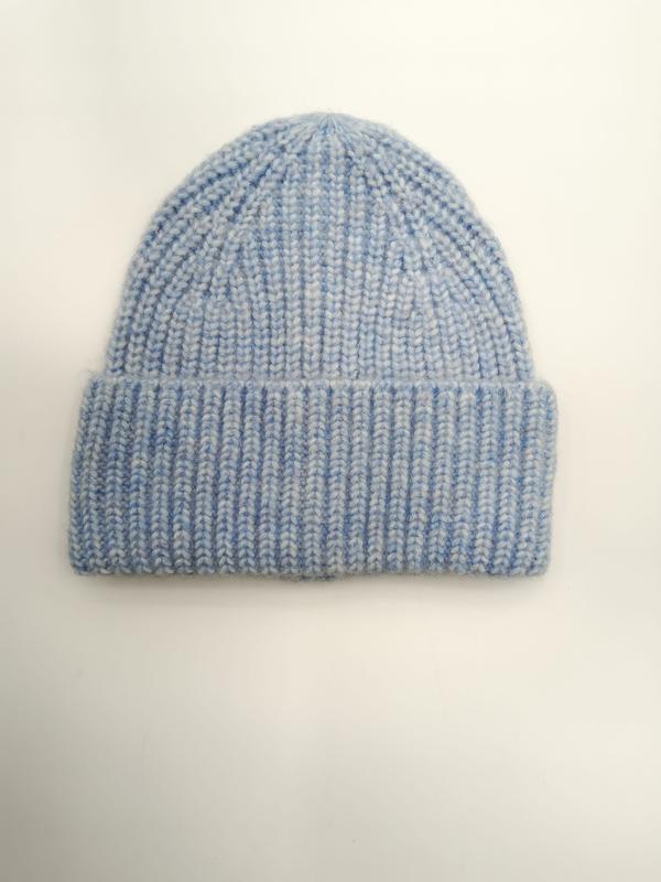 Light blue chunky ribbed knit beanie hat with folded cuff, laid flat on white background, soft marl texture